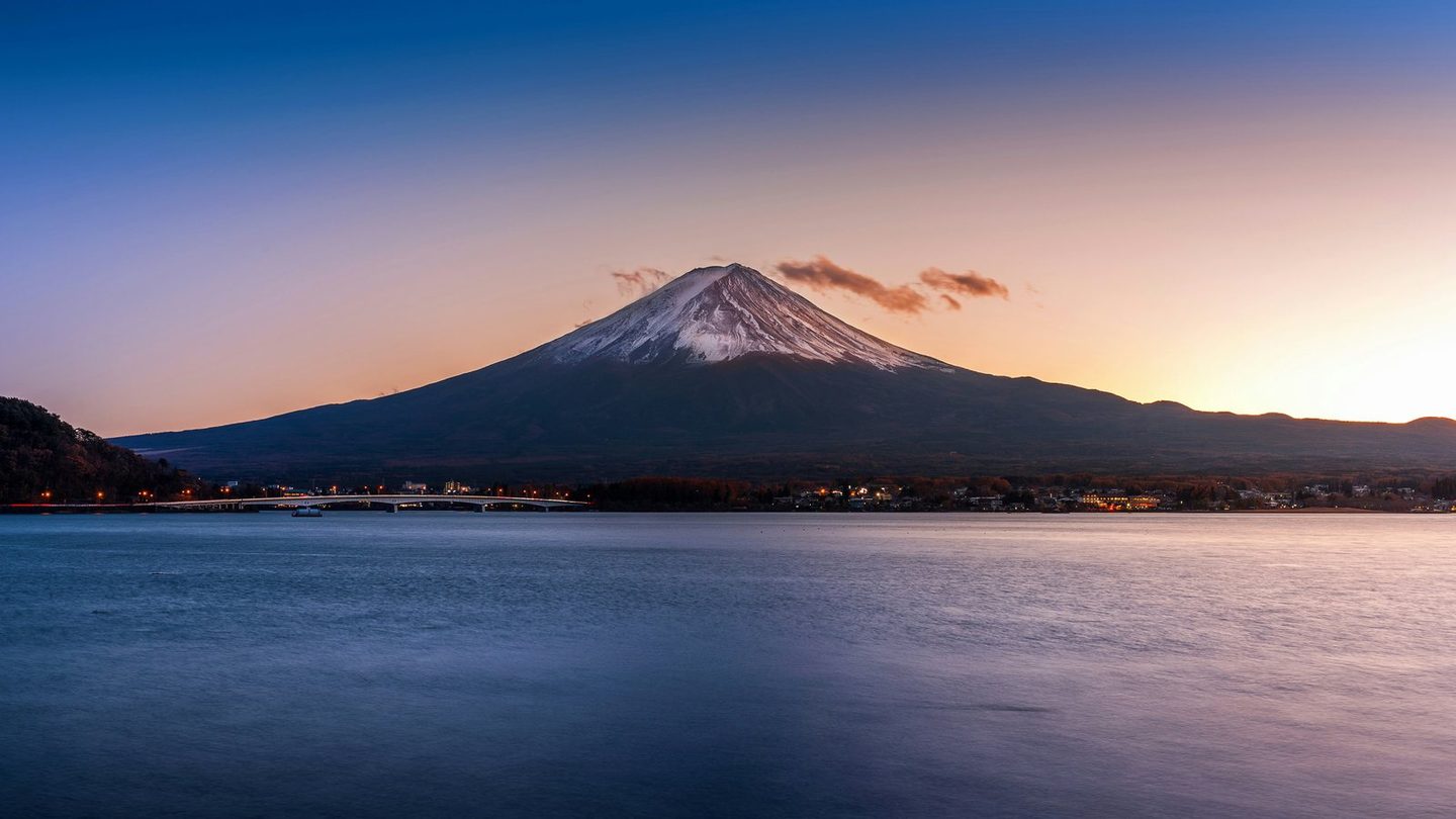 Mount Fuji: a wide, solid base rising to a narrow snow-capped peak