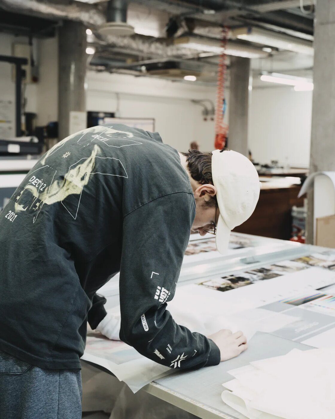 A printer checking proofs on the light table