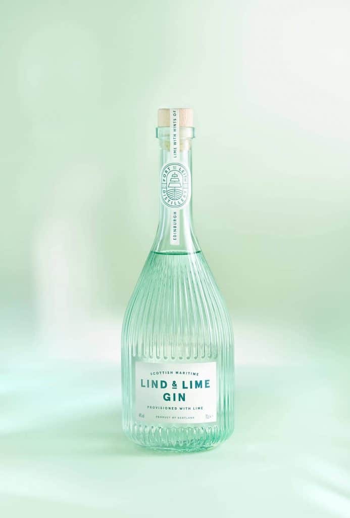 A bottle of gin against a green background photographed by London-based product photographer Max Catterall